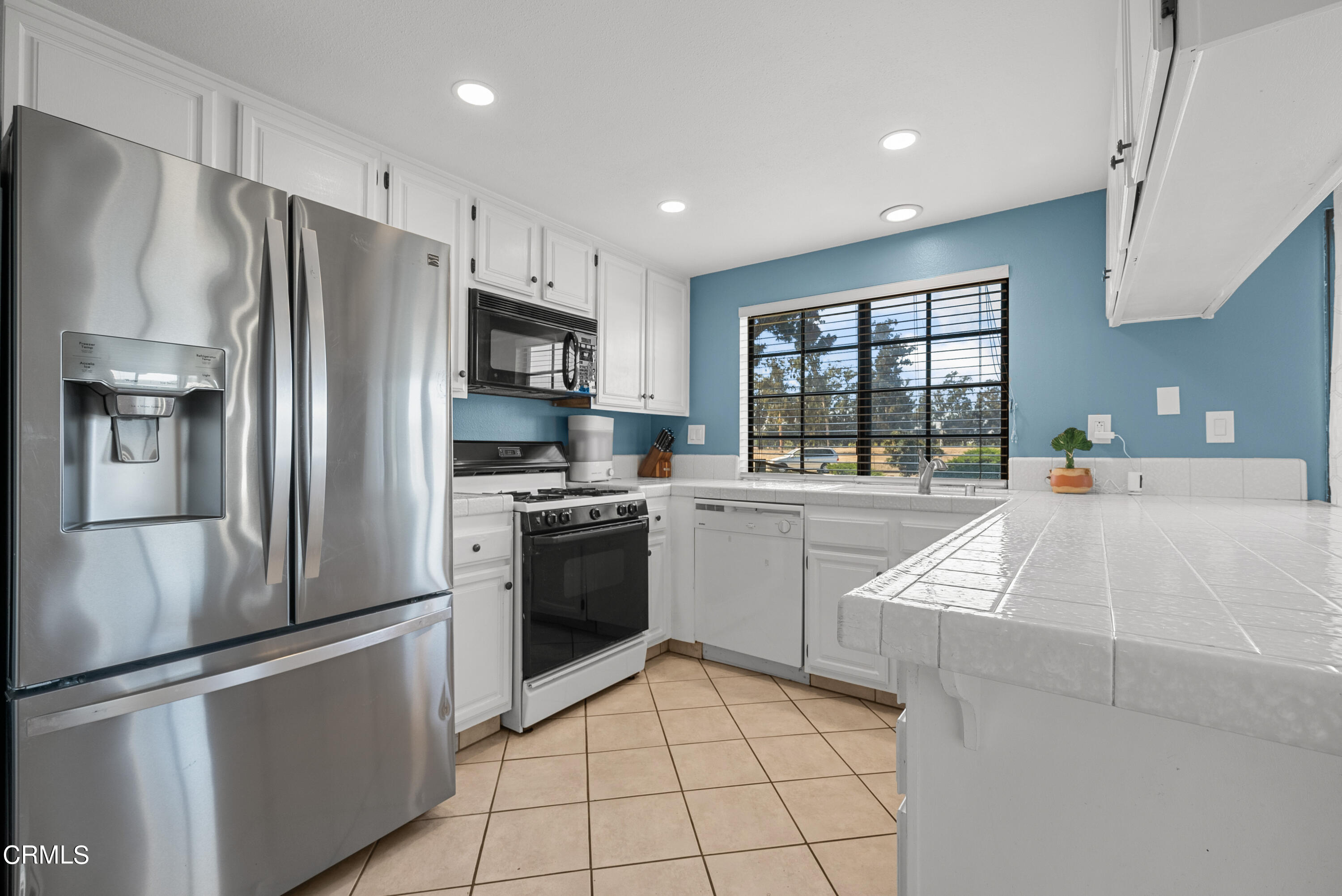 3450 Olds Road Oxnard, CA 93033 - Photo 8 of 30 a kitchen with stainless steel appliances granite countertop a refrigerator sink and stove