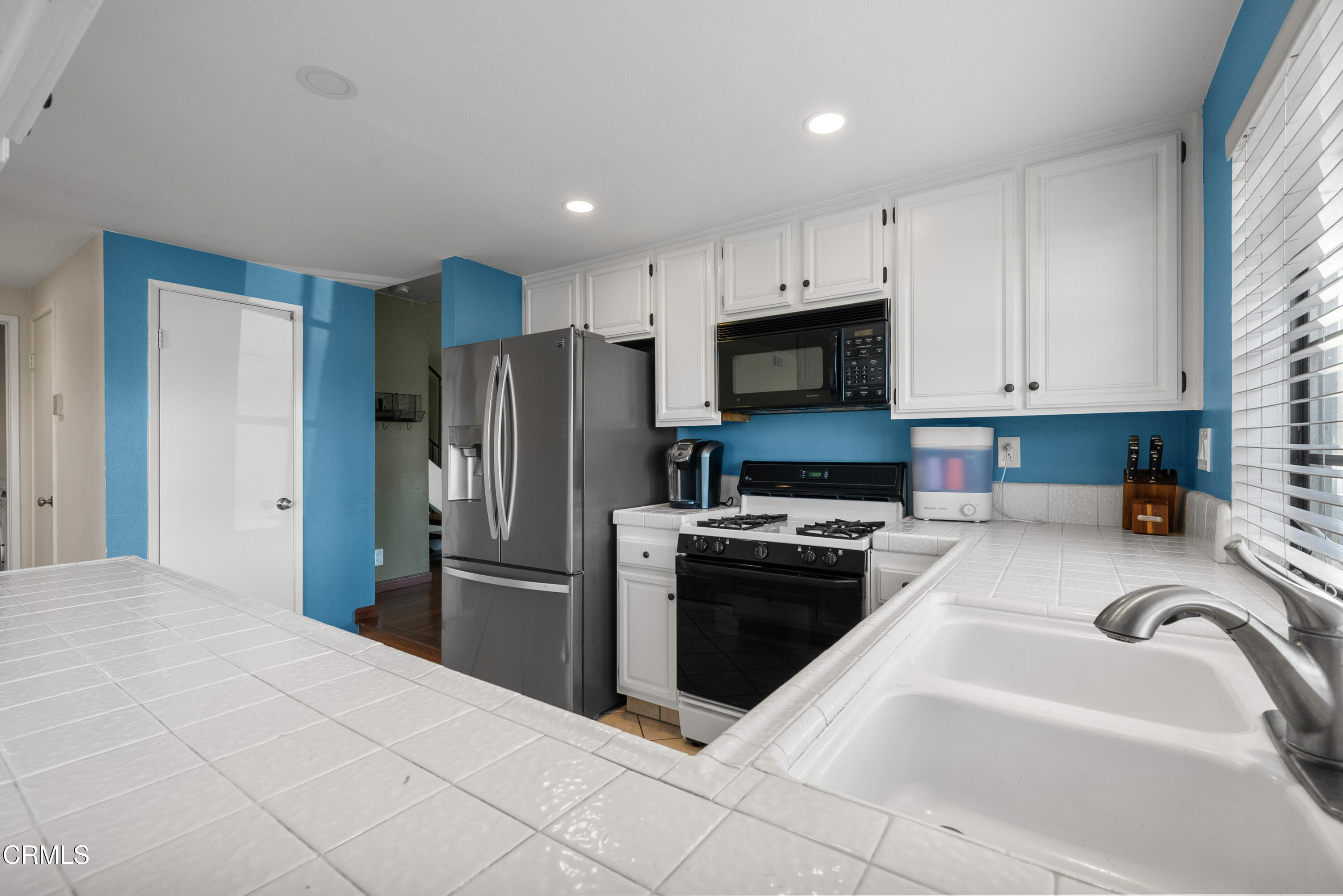 3450 Olds Road Oxnard, CA 93033 - Photo 9 of 30 a kitchen with kitchen island a refrigerator sink and stove