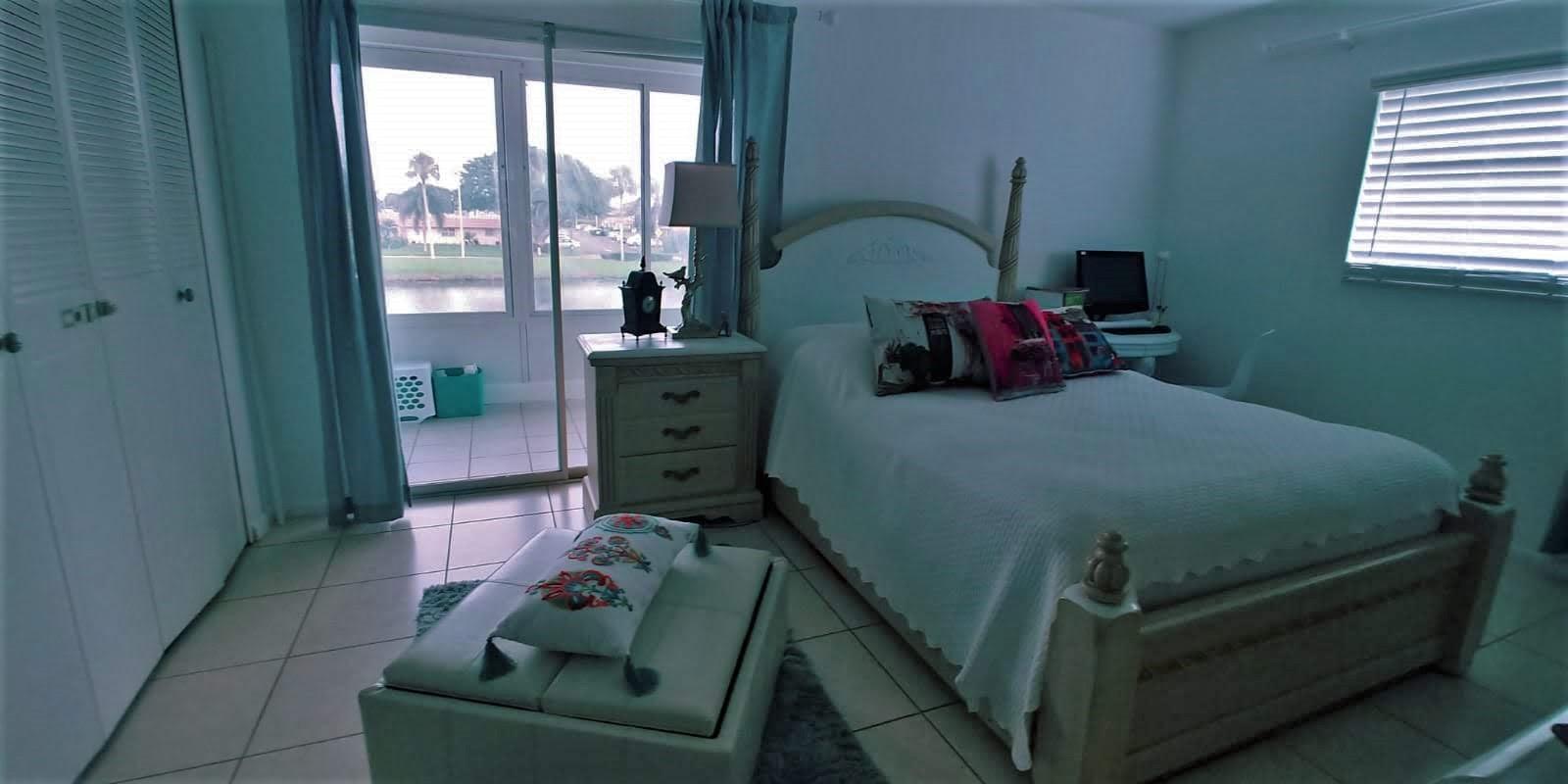 95 Monaco Boulevard, Unit B Delray Beach, FL 33446 - Photo 15 of 46 a bedroom with a bed and a window