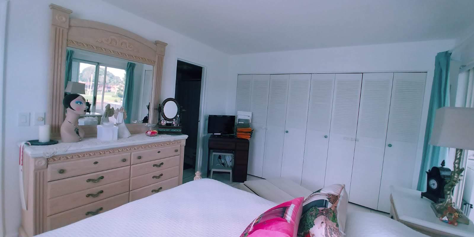 95 Monaco Boulevard, Unit B Delray Beach, FL 33446 - Photo 17 of 46 a bedroom with a bed and a dresser in it