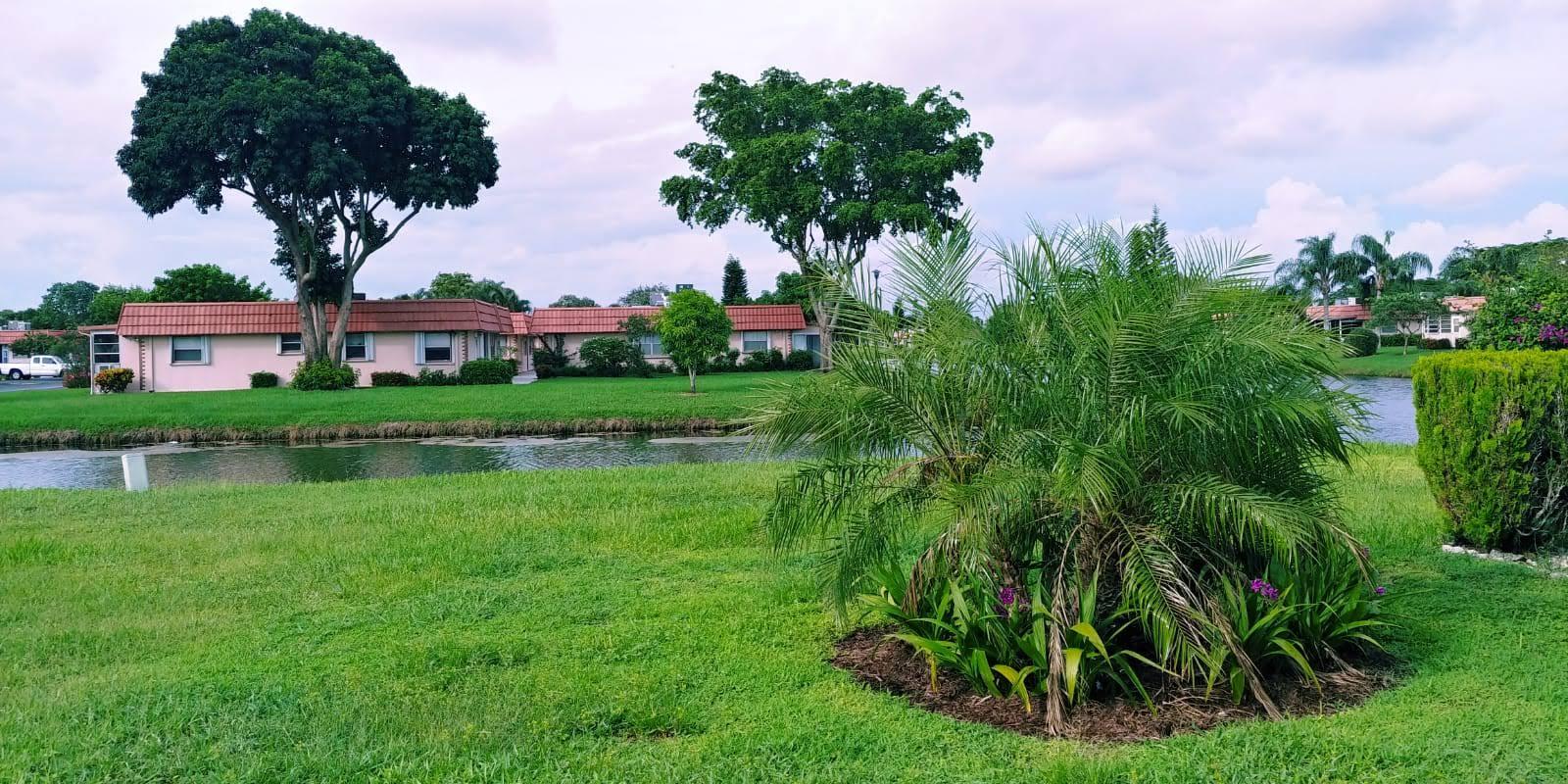 95 Monaco Boulevard, Unit B Delray Beach, FL 33446 - Photo 21 of 46 a house view with a garden space