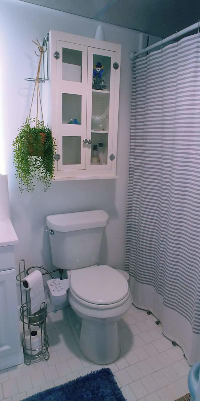 95 Monaco Boulevard, Unit B Delray Beach, FL 33446 - Photo 27 of 46 a white toilet sitting next to a bathroom sink