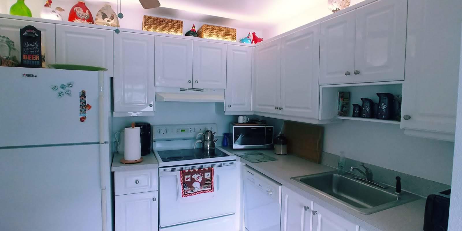 95 Monaco Boulevard, Unit B Delray Beach, FL 33446 - Photo 31 of 46 a kitchen with stainless steel appliances granite countertop a sink a stove and a refrigerator