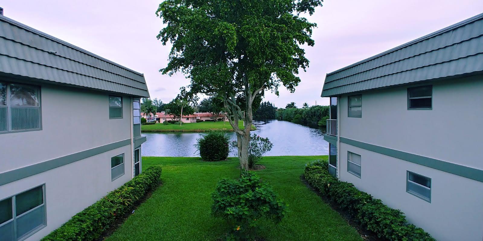 95 Monaco Boulevard, Unit B Delray Beach, FL 33446 - Photo 9 of 46 a view of a house with a yard and a garden