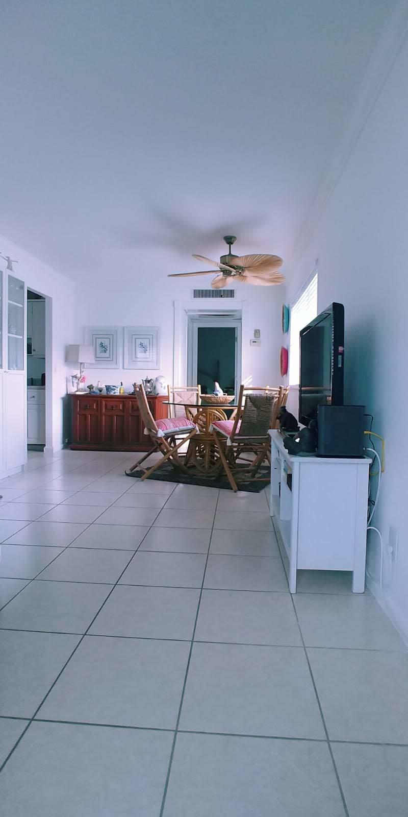 95 Monaco Boulevard, Unit B Delray Beach, FL 33446 - Photo 10 of 46 a living room with furniture and a flat screen tv