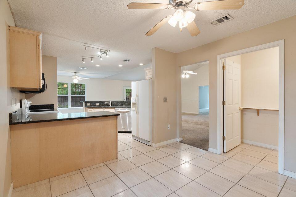 209 Warrior Street Crestview, FL 32536 - Photo 11 of 18 a bathroom with a sink a mirror and a shower