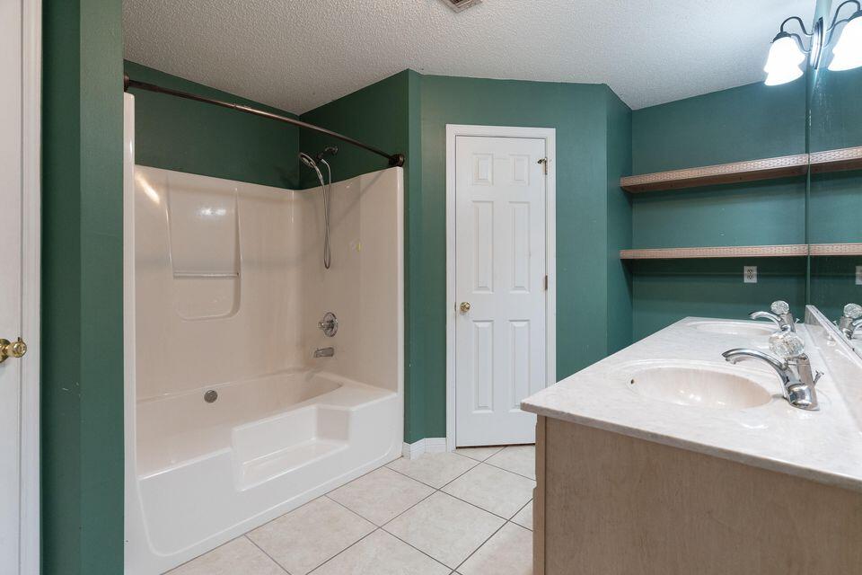 209 Warrior Street Crestview, FL 32536 - Photo 13 of 18 a bathroom with a sink and a shower