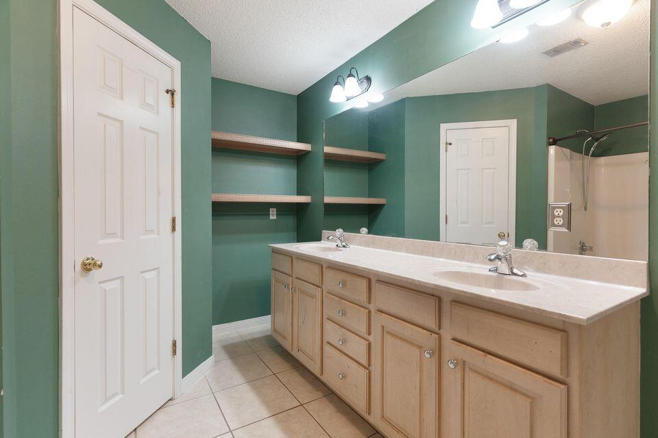 209 Warrior Street Crestview, FL 32536 - Photo 14 of 18 a bathroom with a sink and a mirror