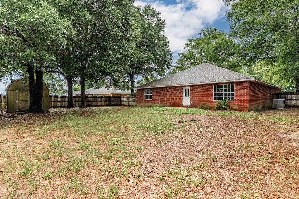 209 Warrior Street Crestview, FL 32536 - Photo 3 of 18 a house that has a tree in front of it