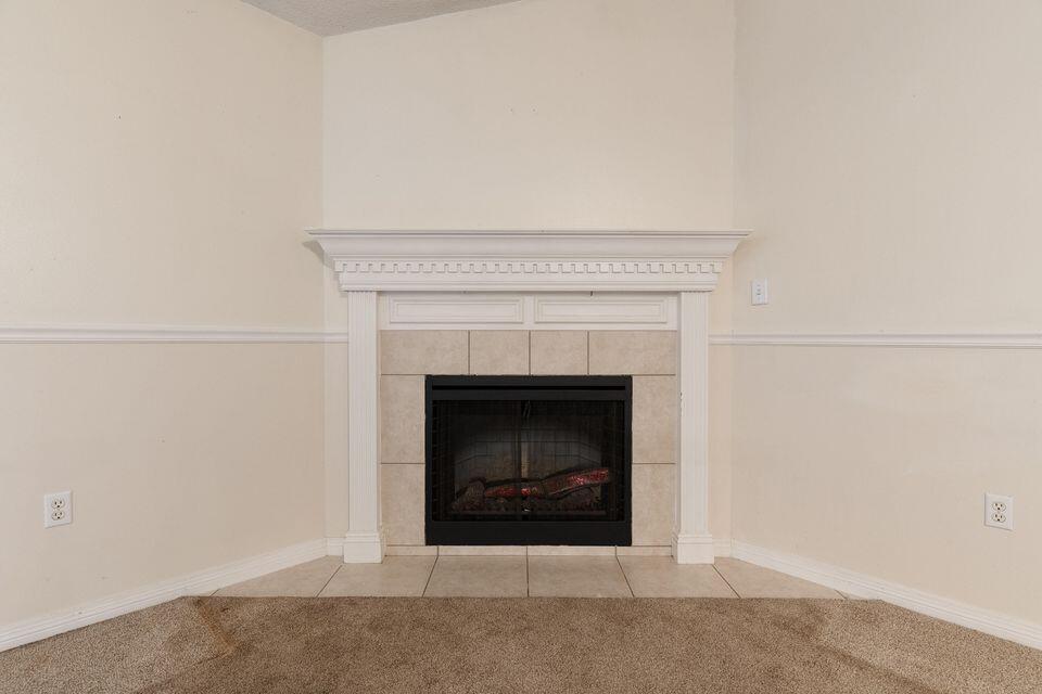 209 Warrior Street Crestview, FL 32536 - Photo 5 of 18 a white building with a fireplace