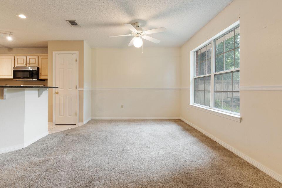 209 Warrior Street Crestview, FL 32536 - Photo 7 of 18 an empty room with a kitchen and a window