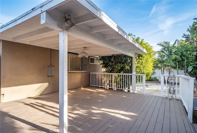 a view of a porch with wooden floor and fence