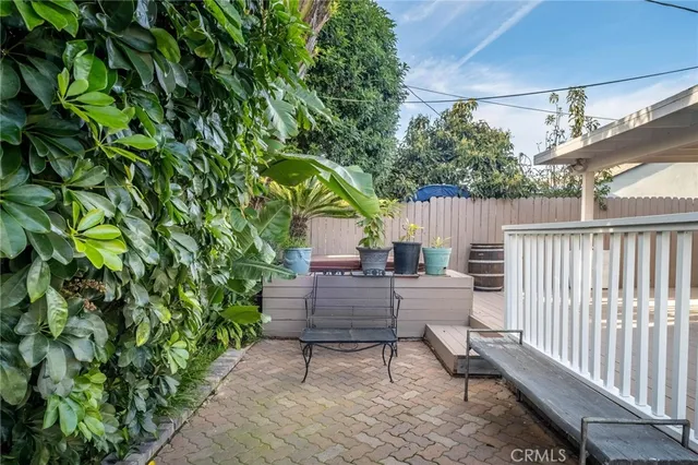 a view of backyard with sitting area and wooden fence