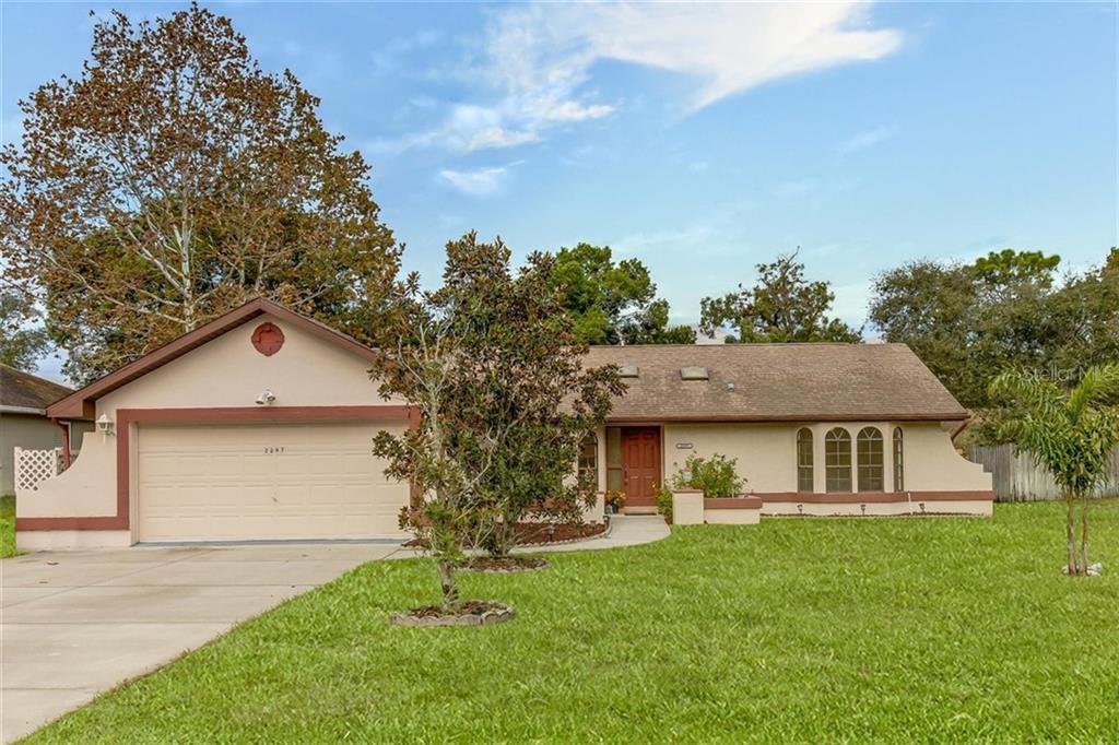 2297 Hawthorne Road Spring Hill, FL 34609 - Photo 1 of 1 front view of a house with a yard