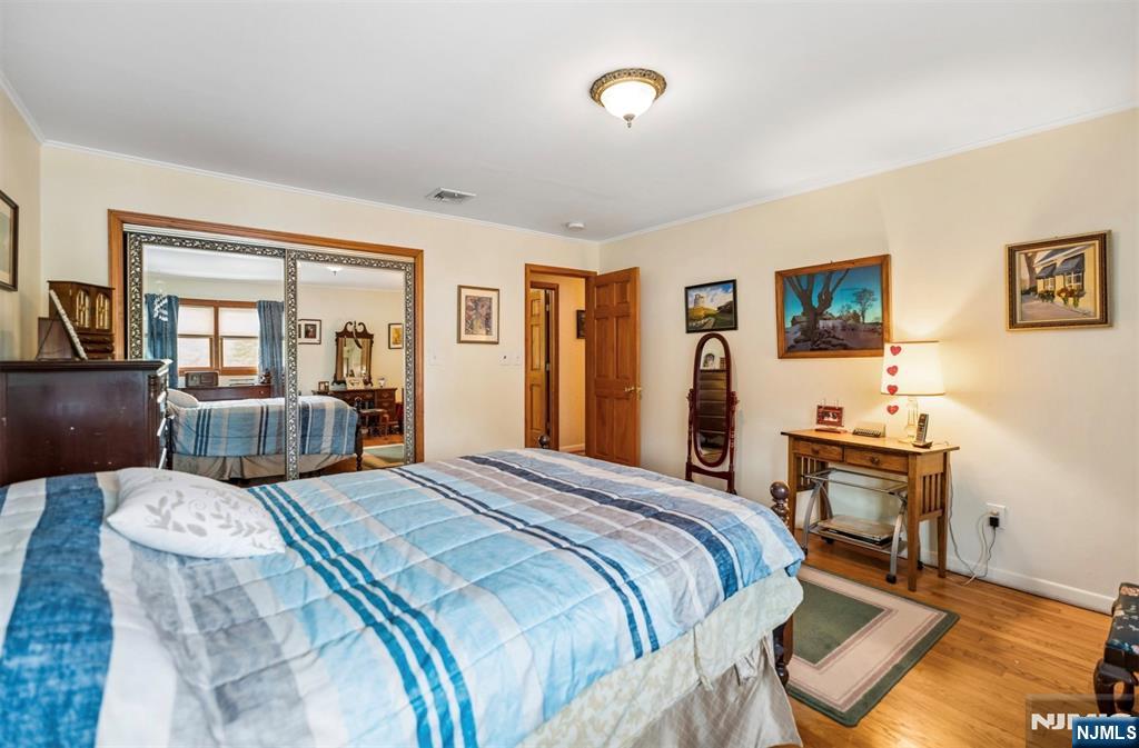 6 Waters Edge Butler, NJ 07405 - Photo 13 of 28 a bedroom with a bed and wooden floor