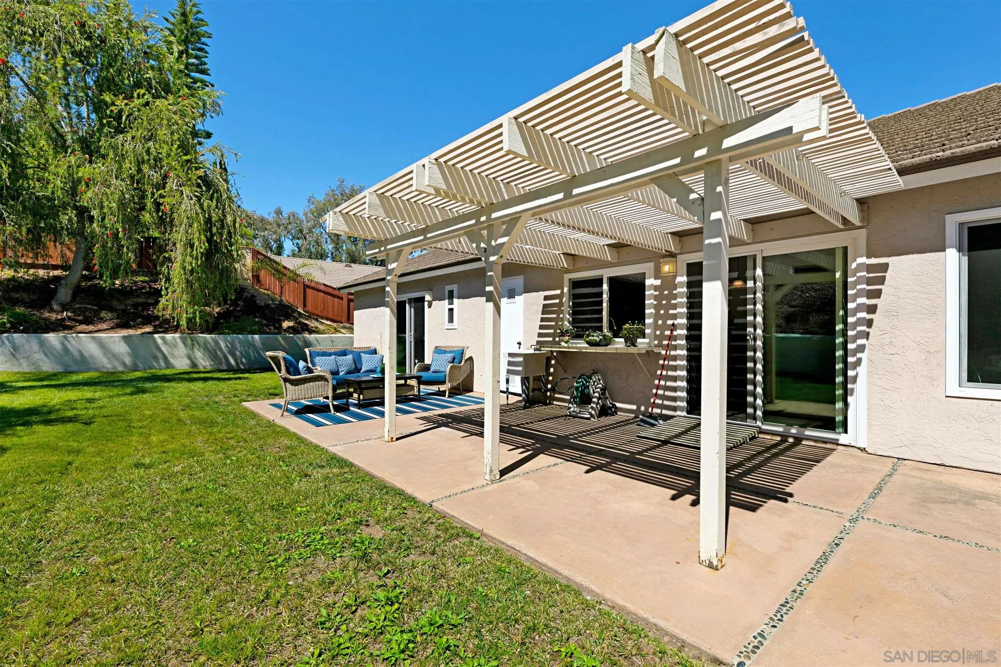 574 Gardendale Road Encinitas, CA 92024 - Photo 26 of 53 a view of a patio with table and chairs near a barbeque