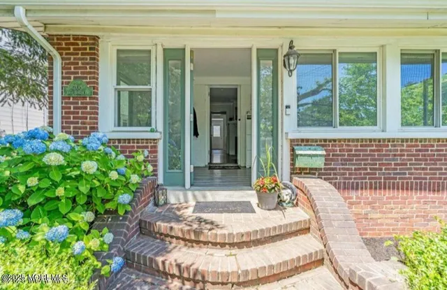 a view of an entryway with wooden floor