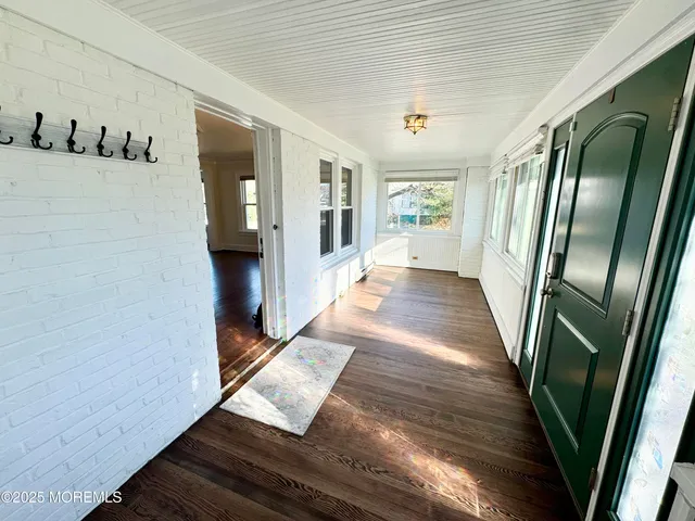 a view of a livingroom with wooden floor a fireplace and window