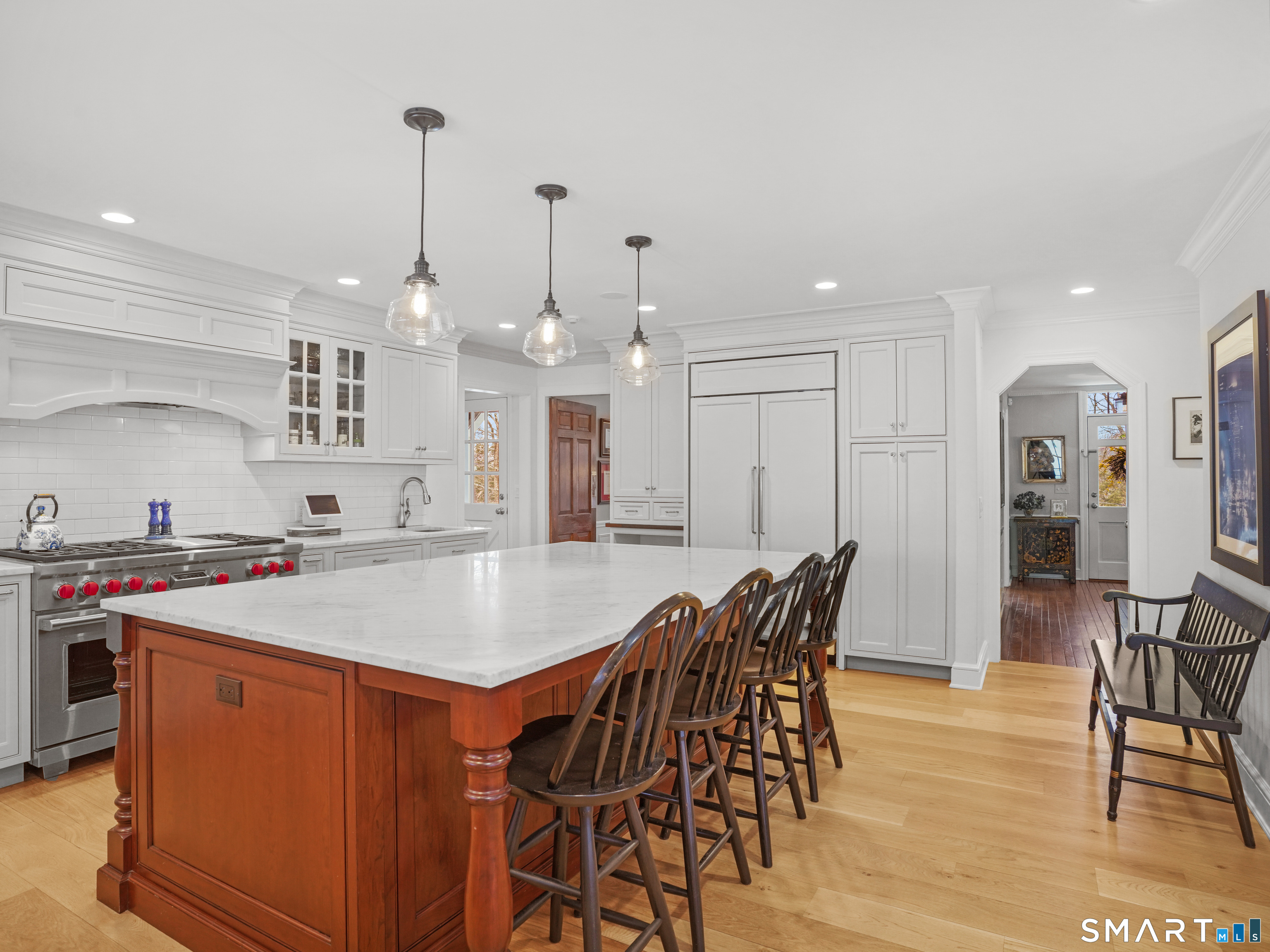 250 Ivy Hill Road Ridgefield, CT 06877 - Photo 17 of 45 a large kitchen with stainless steel appliances a table chairs refrigerator and wooden floor