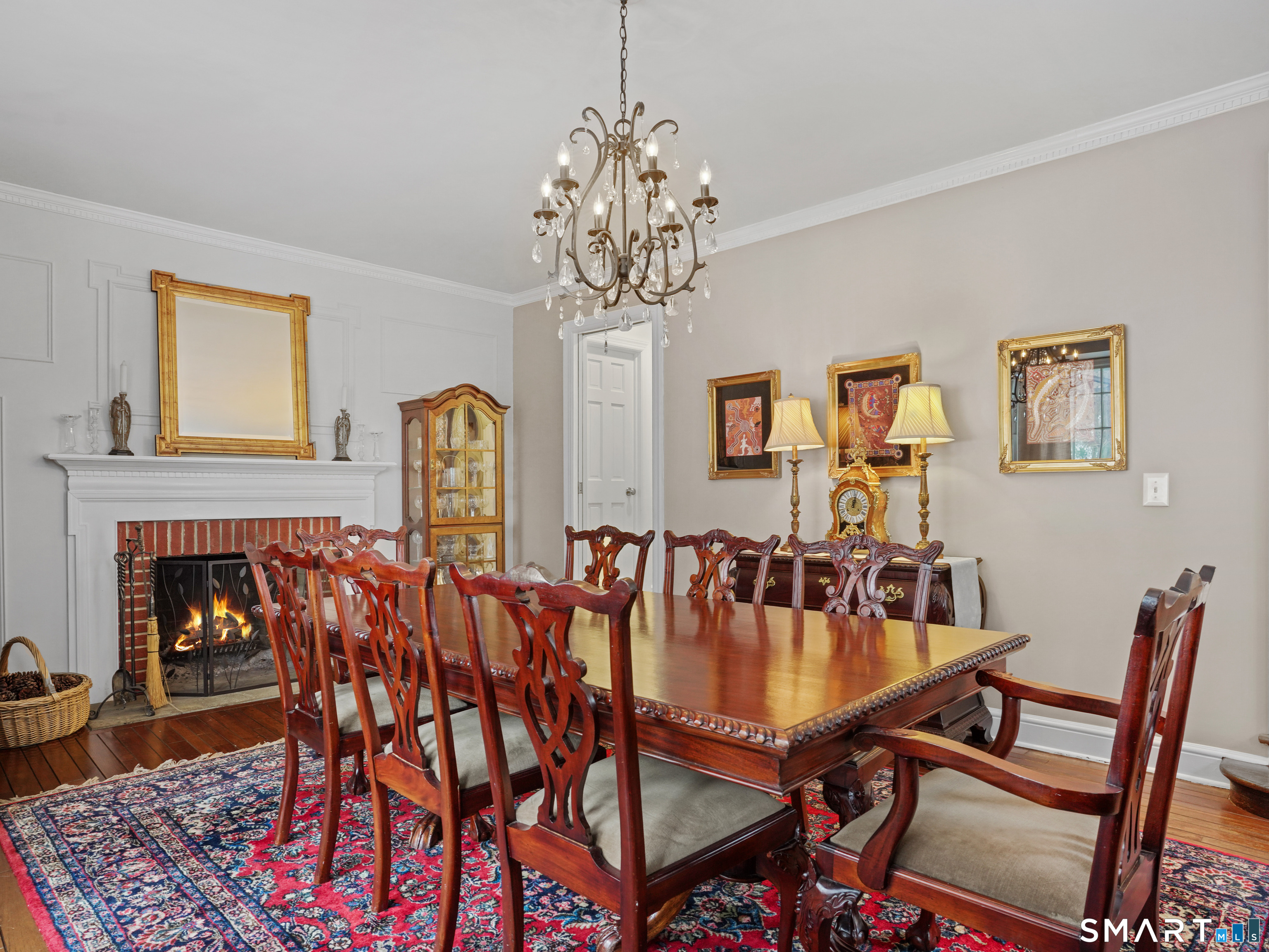250 Ivy Hill Road Ridgefield, CT 06877 - Photo 23 of 45 a dining room with furniture a chandelier and wooden floor