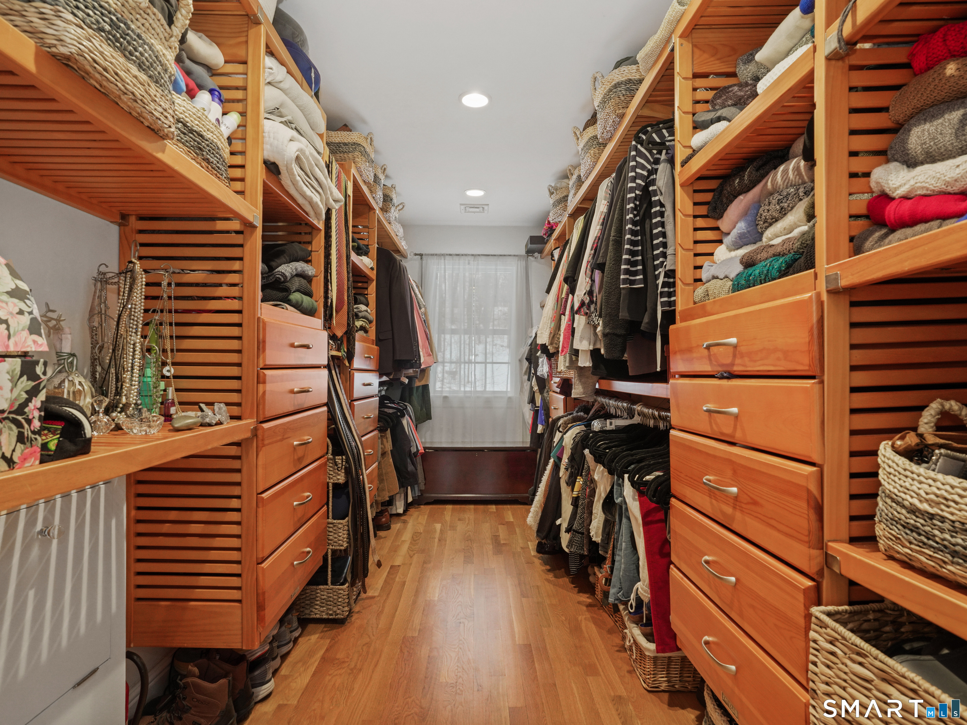 250 Ivy Hill Road Ridgefield, CT 06877 - Photo 33 of 45 a view of walk in closet with clothes and shoes
