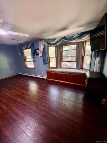 a view of livingroom with hardwood floor and a ceiling fan