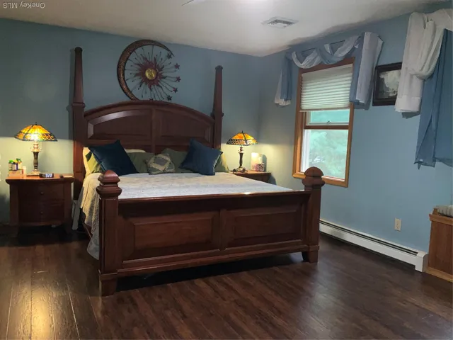 a bed sitting in a bedroom next to a window