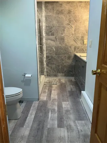 a view of a house with a backyard and a tree