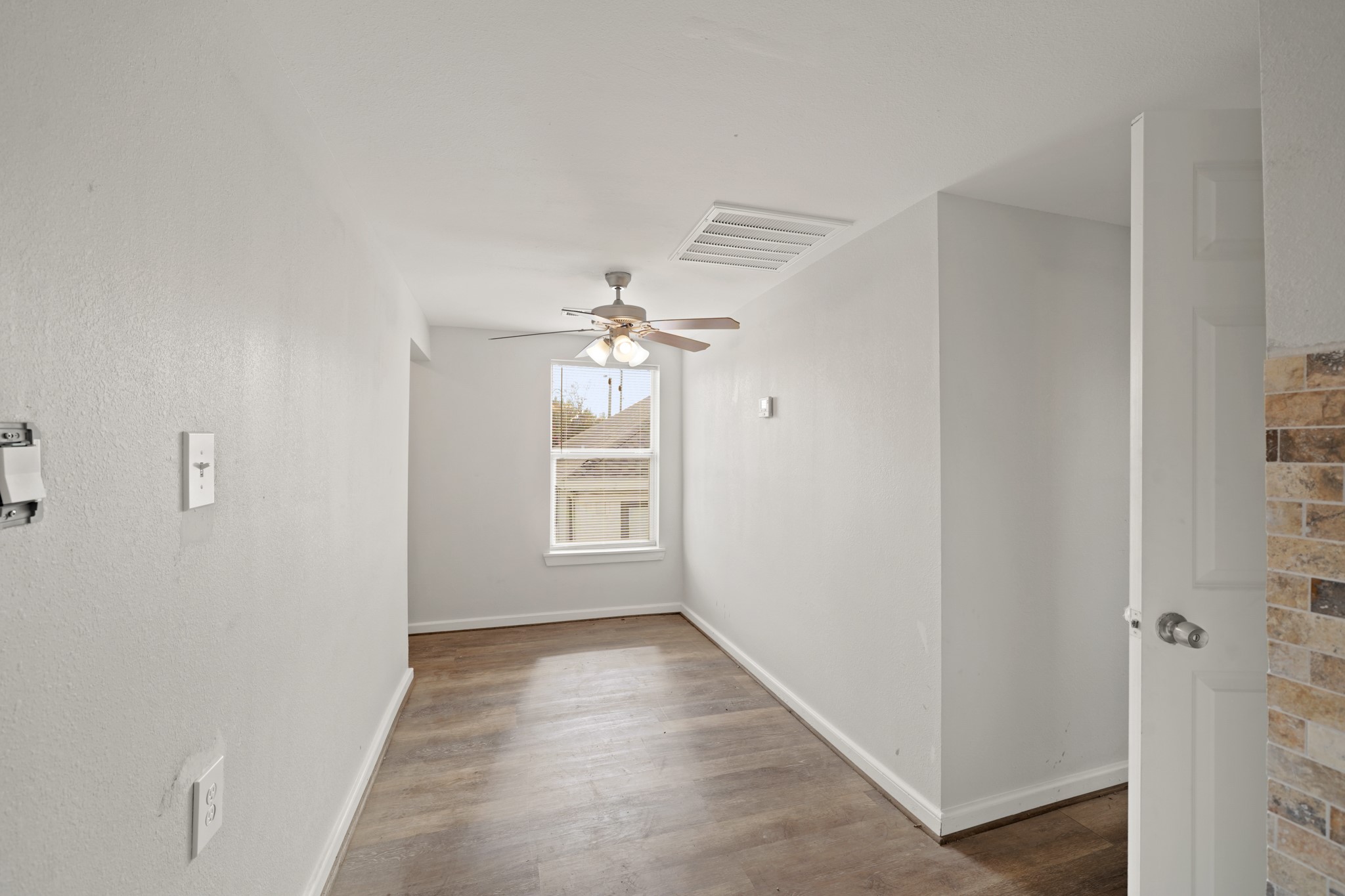 5307 Crane Street Houston, TX 77026 - Photo 15 of 41 Garage apartment -Bright and airy upstairs dining area with ceiling fan, ample natural light, and stylish wood-look flooring.