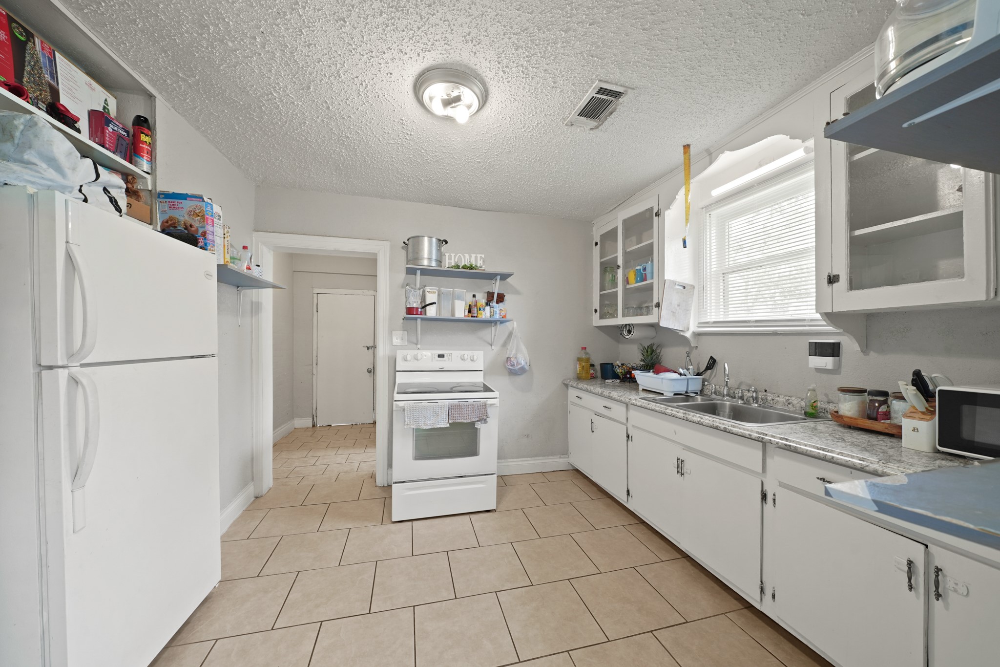 5307 Crane Street Houston, TX 77026 - Photo 23 of 41 a kitchen with granite countertop a refrigerator sink and cabinets