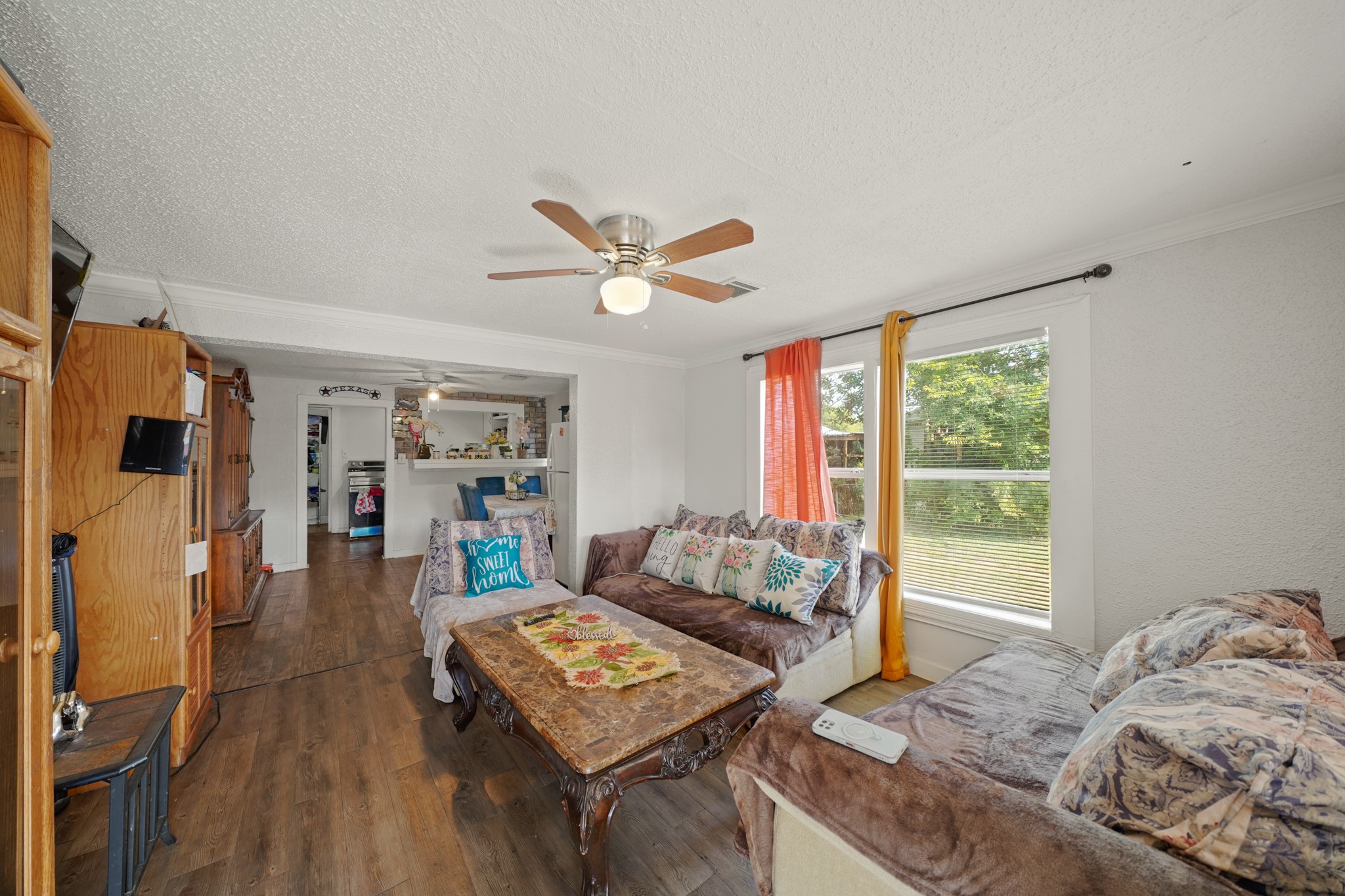 5307 Crane Street Houston, TX 77026 - Photo 4 of 41 4003 Lockwood -Bright living room with wood-look flooring, a ceiling fan, and large windows providing abundant natural light.