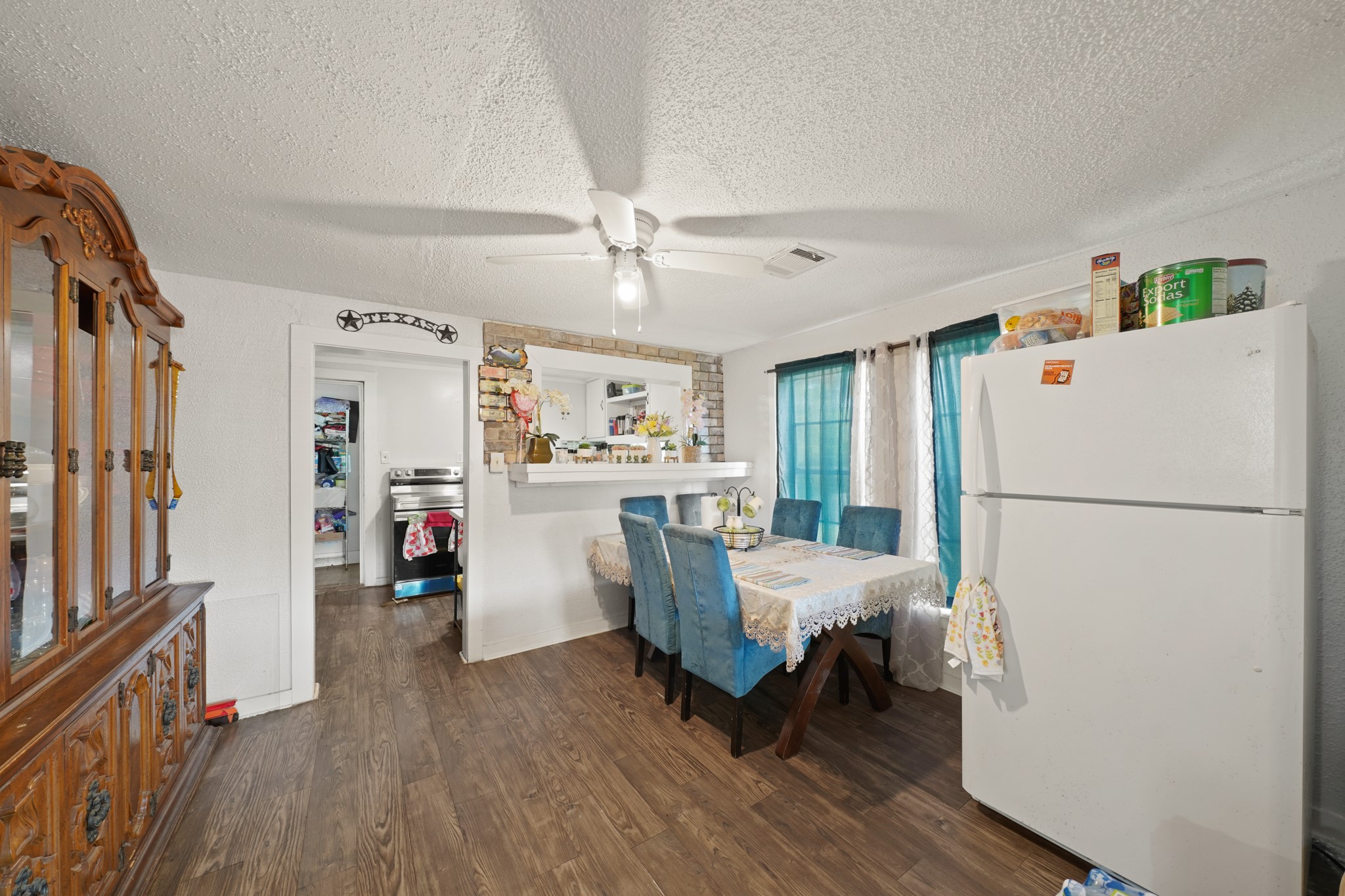5307 Crane Street Houston, TX 77026 - Photo 6 of 41 4003 Lockwood -Spacious dining area featuring wood-look floors, a ceiling fan, and a convenient pass-through to the kitchen.