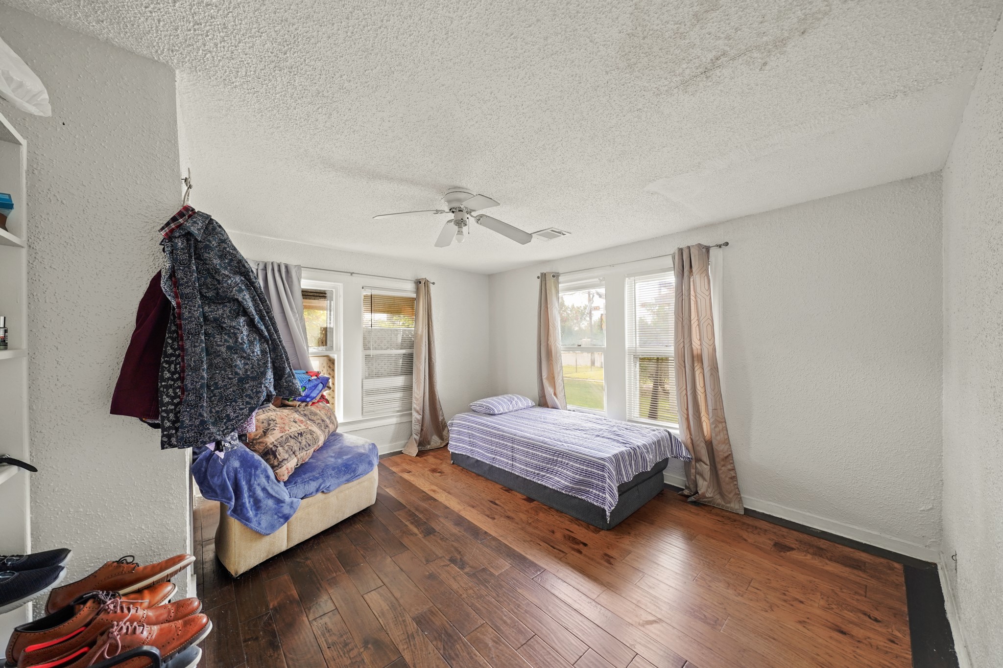 5307 Crane Street Houston, TX 77026 - Photo 10 of 41 a bedroom with a bed and wooden floor