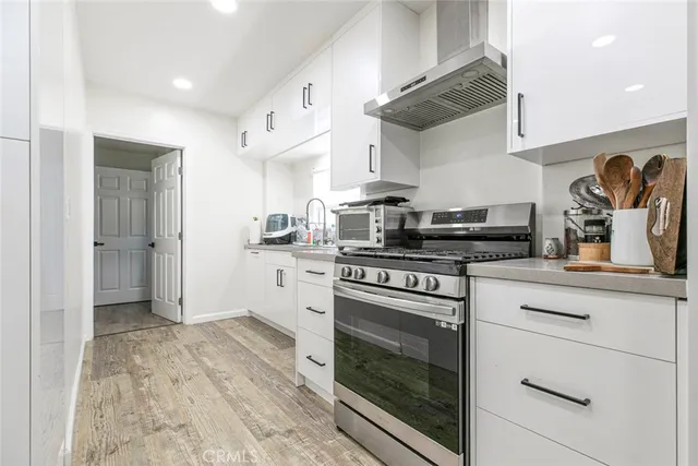 a kitchen with stainless steel appliances granite countertop a stove and a refrigerator