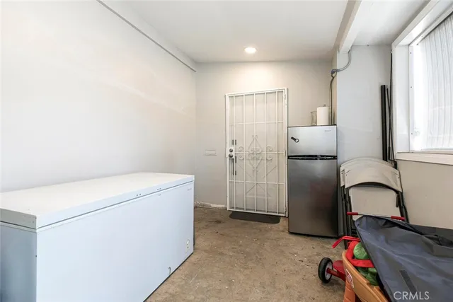 a view of hallway with stairs and a window