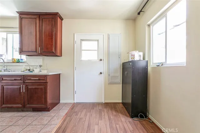 a view of a livingroom with wooden floor and a flat screen tv