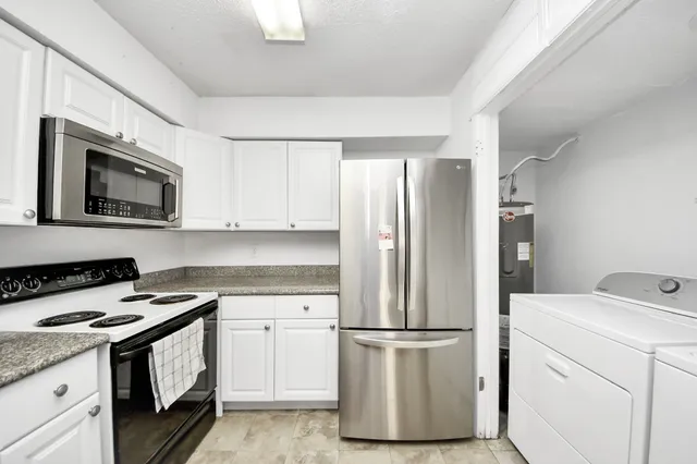 a kitchen with appliances a sink and a stove