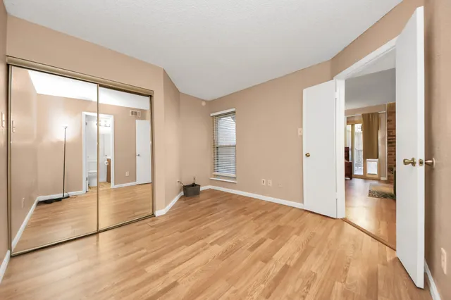 a view of a room with wooden floor and windows