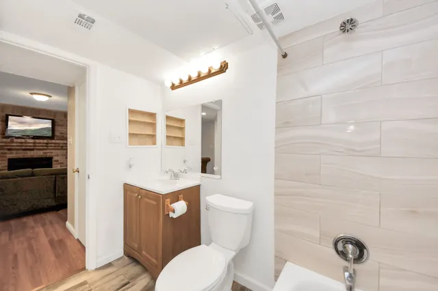 a bathroom with a toilet a sink and shower