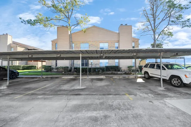 a view of a car parked in front of a building