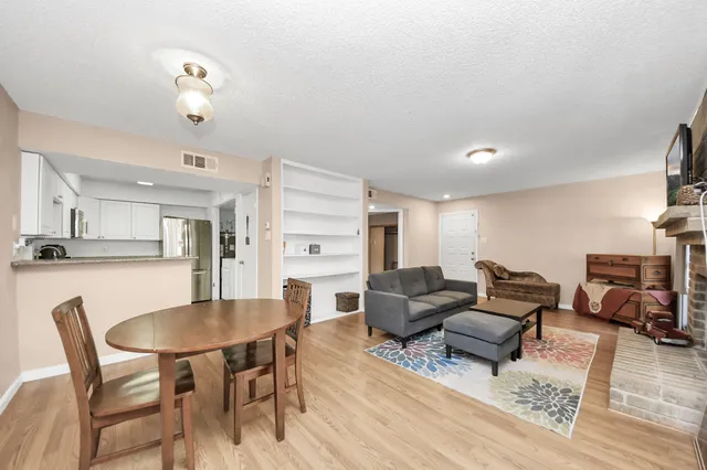 a living room with furniture kitchen view and a dining table