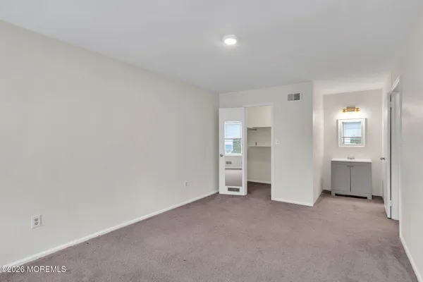 a view of an empty room and a window