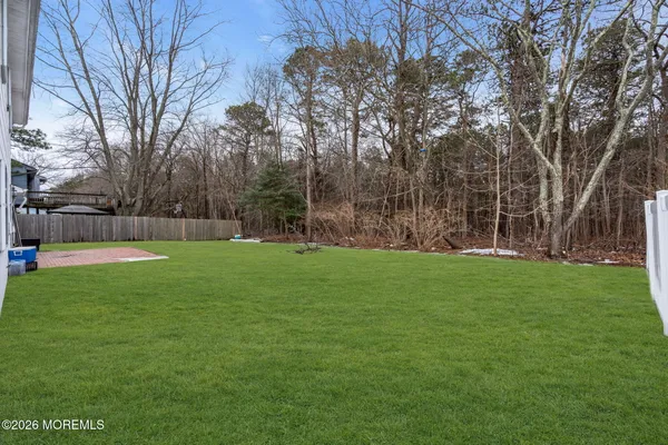 a view of yard with trees in the background