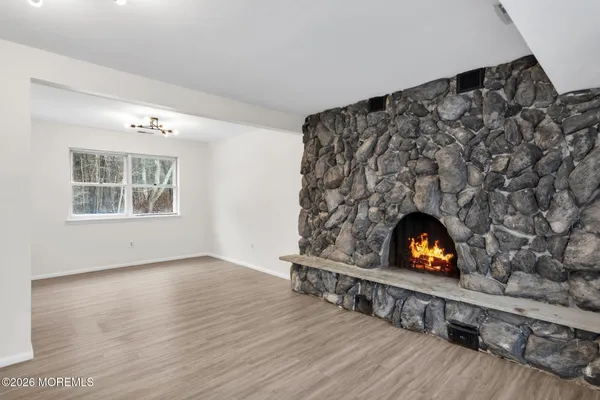 an empty room with furniture and a fireplace