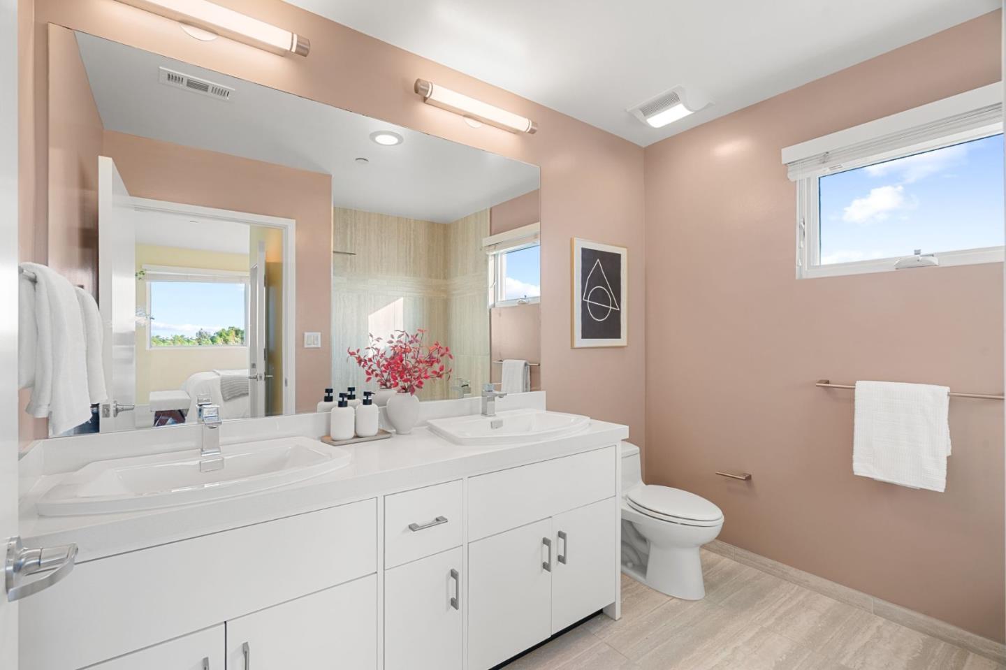 1838 Ogden Drive, Unit 413 Burlingame, CA 94010 - Photo 11 of 23 a bathroom with a double vanity sink mirror and toilet