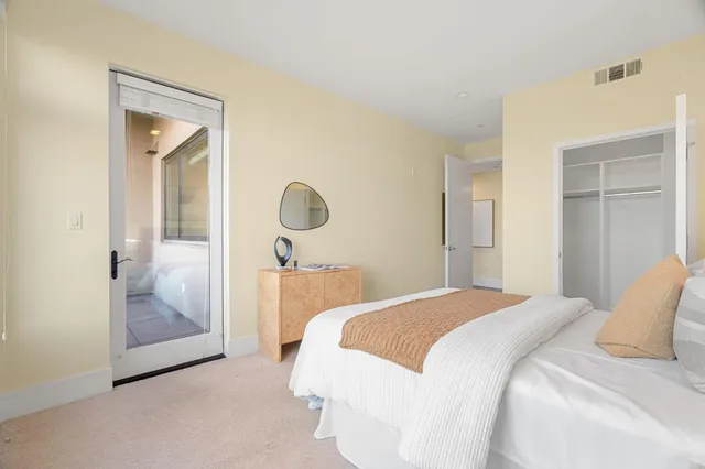 a bedroom with a bed and glass door