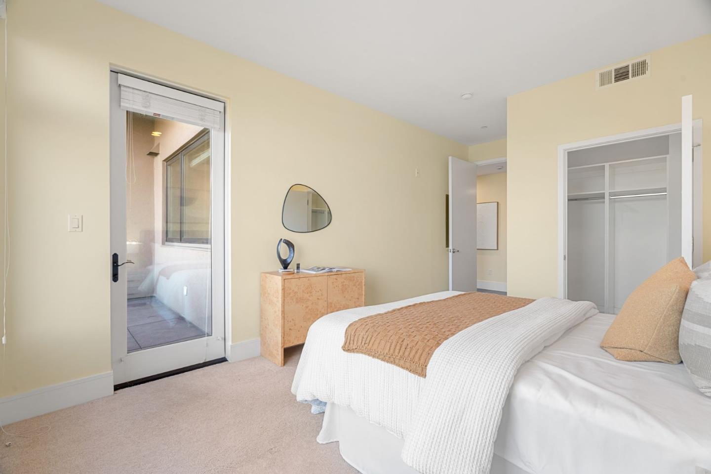 1838 Ogden Drive, Unit 413 Burlingame, CA 94010 - Photo 14 of 23 a bedroom with a bed and glass door
