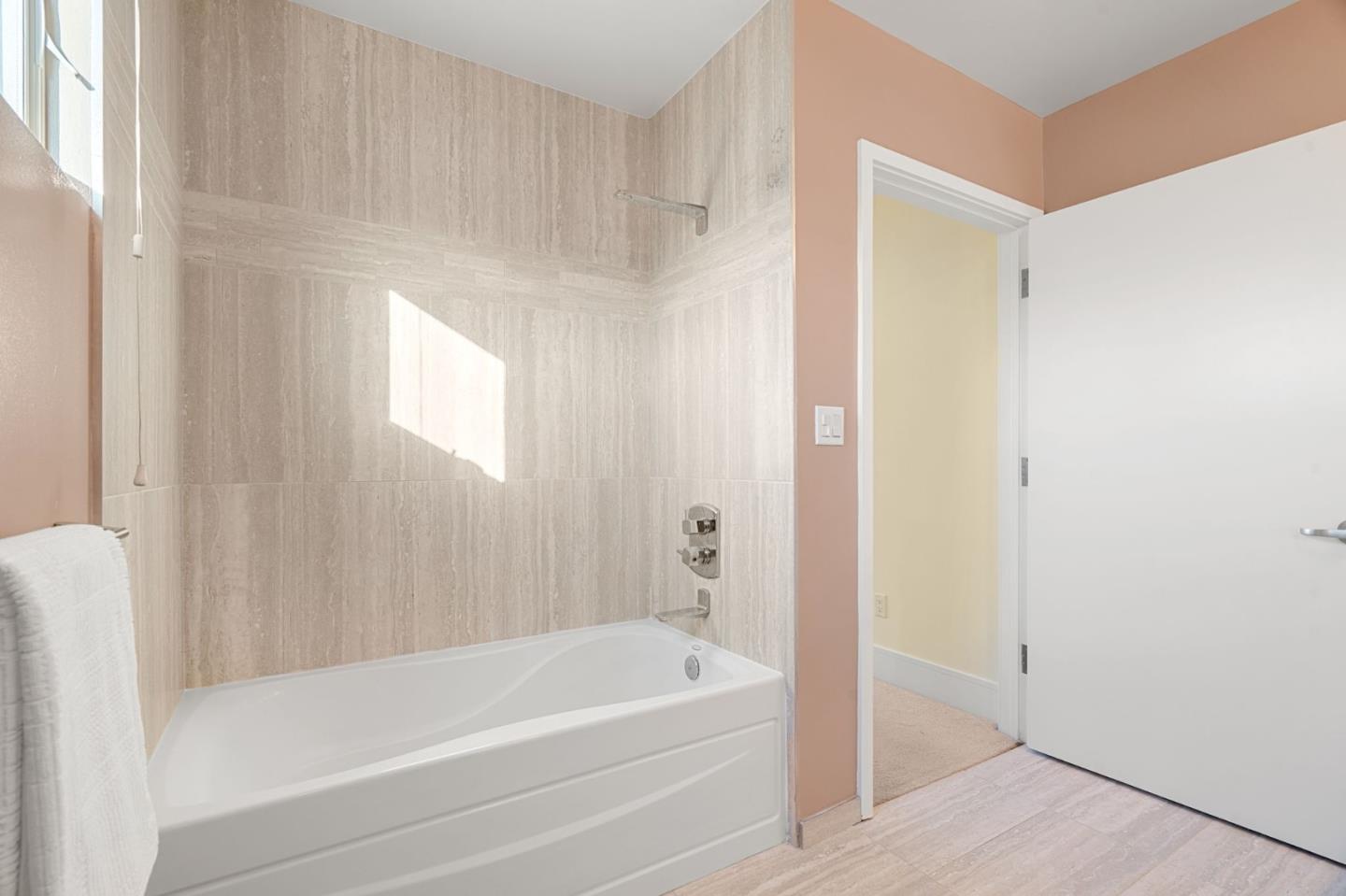 1838 Ogden Drive, Unit 413 Burlingame, CA 94010 - Photo 18 of 23 a bathroom with a bathtub and a shower