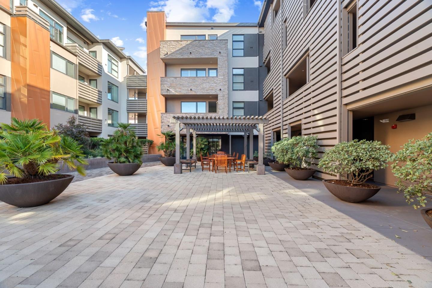 1838 Ogden Drive, Unit 413 Burlingame, CA 94010 - Photo 20 of 23 a view of a building with potted plants