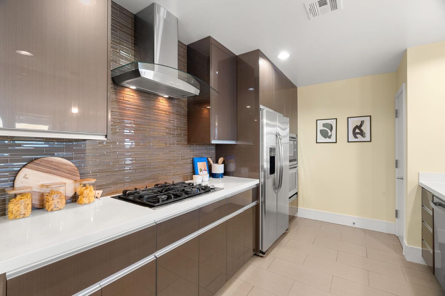 1838 Ogden Drive, Unit 413 Burlingame, CA 94010 - Photo 4 of 23 a kitchen with stainless steel appliances granite countertop a stove a sink and a refrigerator